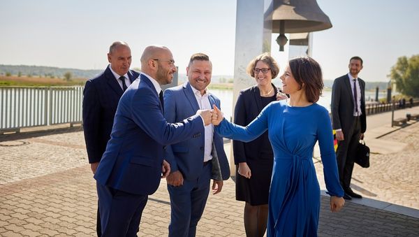 Außenministerin Annalena Baerbock schüttelt Frankfurts Oberbürgermeister René Wilke die Hand an der Friedensglocke